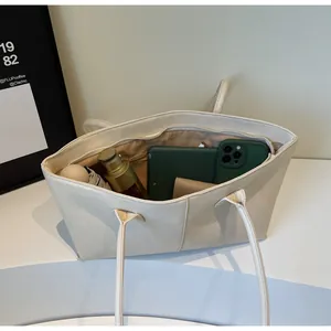 Top view of cream white leather tote bag showing large capacity for essentials