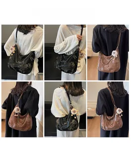 Hobo tote bag details showing black and brown synthetic leather with metal chain deco