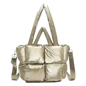 Quilted champagne gold padded tote bag with metallic sheen and adjustable shoulder strap