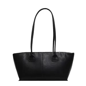 Minimalist black leather tote bag with long shoulder straps and central vertical stitching