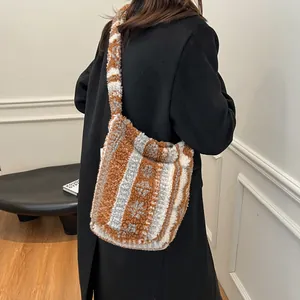 Bolso tote de felpa invernal con rayas marrones y grises sobre un abrigo de lana negro