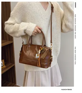 Brown vintage pillow bag with abacus charm shown on a model for lifestyle scale