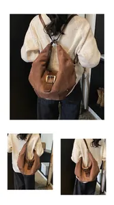 Detail of soft brown suede crescent bag with buckle closure and leather strap