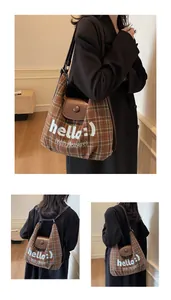 Detail of vintage brown plaid bag with premium leather flap and white embroidery