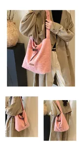 Close-up of pink fuzzy tote bag detail featuring brown leather label and plaid lining