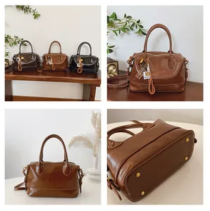 Detailed views of vintage boston bags in brown and black with polished finish and metal feet