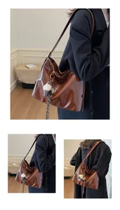 Detail view of deep brown polished leather tote featuring a stylish fluffy keychain accessory