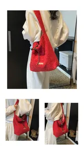 Detailed macro of red faux shearling tote with our fave label and plaid lining