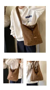 Detail of brown plush tote bag showing 'our fave' patch and checkered fabric lining