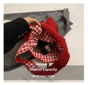 Detailed interior of red plush tote bag showing inner pocket and red checkered lining