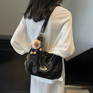 Chic black faux leather tote bag with silver chain decor and cute sheep plush charm for women