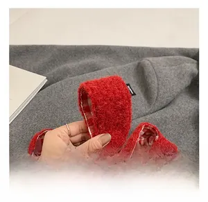 Close-up of soft red plush tote handle with a red and white checkered inner lining