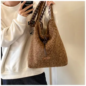 Close-up of brown plush tote bag showing soft texture and our fave cloth label detail