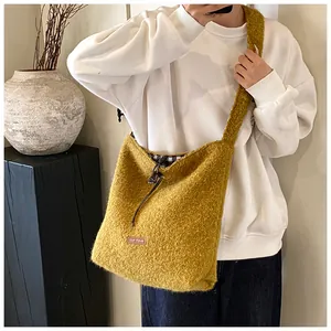 Detailed view of mustard plush tote bag with drawstring closure and checkered lining