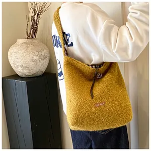 Detail of yellow plush tote bag with our fave leather patch and fuzzy wool texture