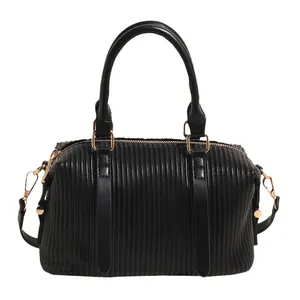 Retro black leather bucket bag with vertical pleated texture and gold-tone hardware