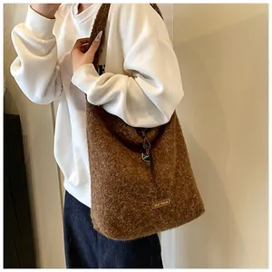 Detail of brown plush tote bag showing the soft texture and a small our fave leather label
