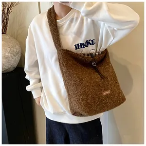Detail of soft brown faux fur tote bag showing plush texture and brand label