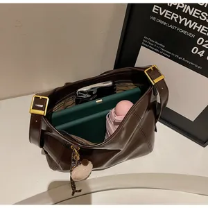 Internal view of a spacious dark brown leather tote bag with tablet and daily items