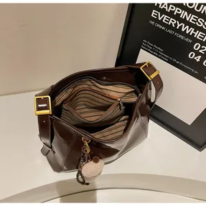 Overhead view of large dark brown tote bag showing striped lining and inner zipper pocket