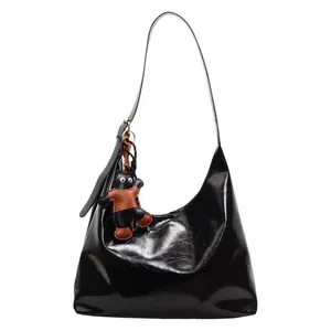 Minimalist black glossy leather hobo tote bag for women with a cute black cat pendant charm