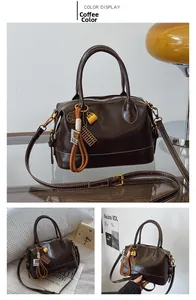 Detail of coffee brown retro Boston bag featuring white contrast stitching and gold hardware