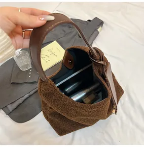 Macro shot of faux shearling tote bag interior with leather pocket and magnetic snap