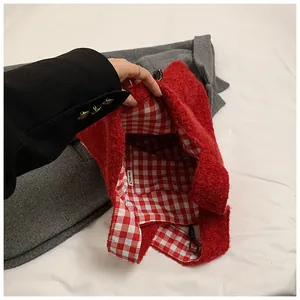 Close-up of red plush tote bag interior with red checkered lining and inner pocket