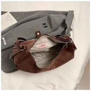 Close-up of the deep brown vintage handbag interior with zippered pocket and silver hardware