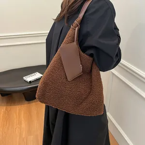 Large brown faux shearling tote bag with smooth leather straps and small card pouch