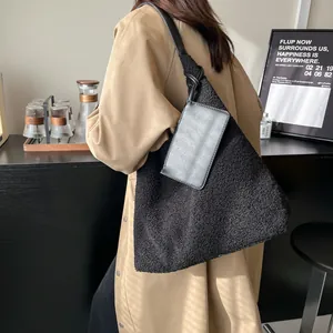 Large black sherpa tote bag with leather straps and small pouch for winter commuting