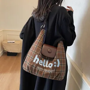 Brown vintage checkered tote bag with leather flap and 'hello' print for daily commute