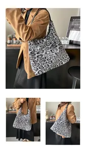 Detailed view of plush leopard print tote bag with soft faux fur and black leather strap