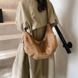 Retro camel suede half-moon shoulder bag with metal rivets and adjustable strap
