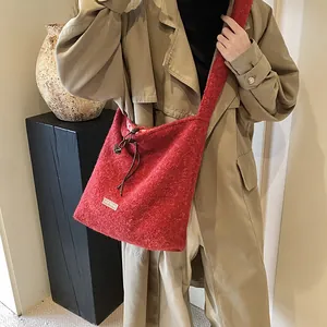 Red plush tote bag with drawstring and our fave label, cozy winter shoulder bag style