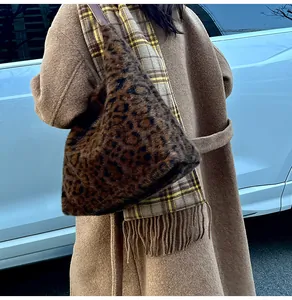 Detail of leopard print faux fur tote bag styled with a wool coat and checkered scarf