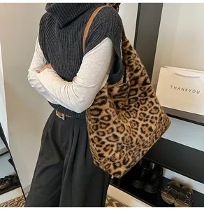 Detail of plush leopard print tote bag featuring premium faux fur texture and brown leather strap