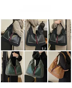 Macro shot of vintage tote bags with rivets and stylish woven rope charms in three colors