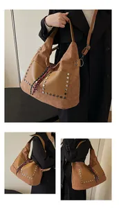 Detailed view of brown large bucket bag featuring silver rivets and woven tassel charm