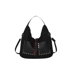 Large black canvas hobo bucket bag with silver hexagonal rivets and braided rope charm