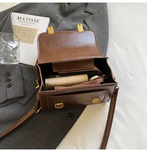 Interior view of dark brown leather crossbody bag showing inner pockets and storage space