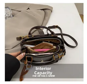 Internal capacity of dark brown leather crossbody bag with multiple compartments and gold hardware
