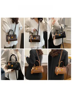 Detail showing vintage rectangular handbag with metal buckle and detachable shoulder strap