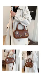 Detail view of American vintage brown Boston bag featuring unique embroidery patches