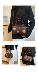Detail of brown vintage PU leather square bag with retro patches and adjustable strap