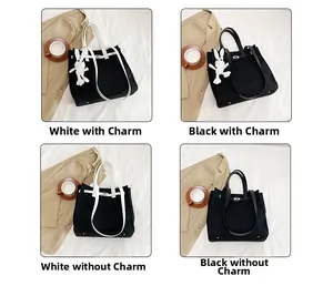 Close-up of Kelly buckle detail on canvas tote bag with various strap options