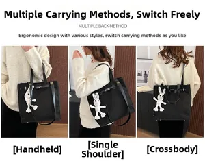 Black canvas tote bag showing handheld, shoulder, and crossbody styles with a metal clasp