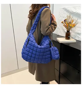 Detail of Klein blue quilted cloud tote bag with side pouch worn by model