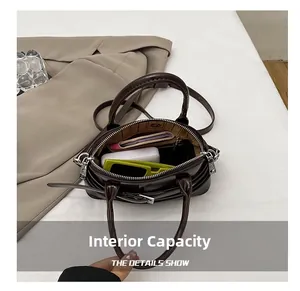 Internal capacity of the vintage brown crossbody bag showing daily essentials