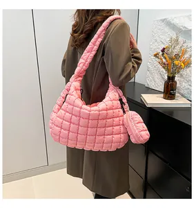 Pink quilted puffy tote bag with matching round coin pouch shown on a shoulder
